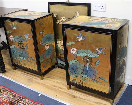 A pair of Chinese lacquered cabinets and a lacquered panel W.55.5cm and 61cm